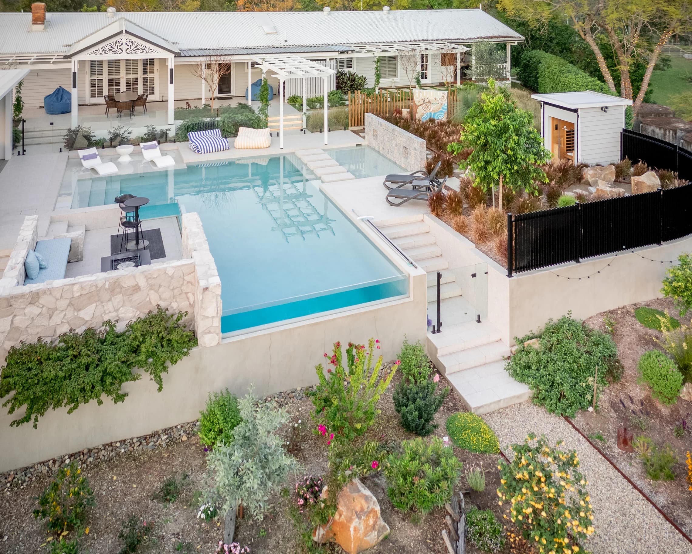 Aerial view of the homestead pool with loungers and a shaded pavilion.