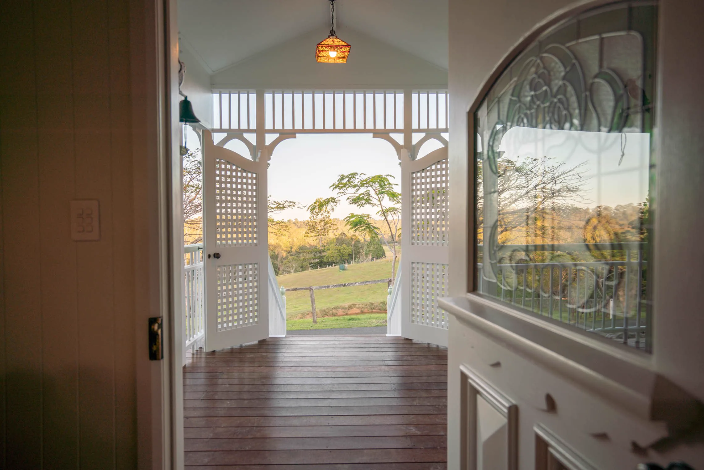 Looking through the stained-glass front door to the veranda and the paddocks.