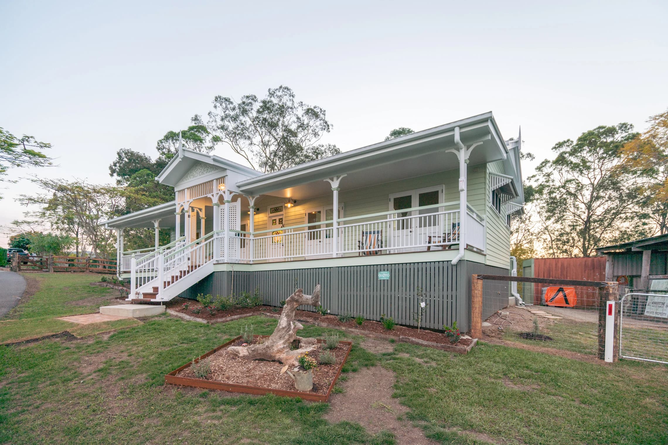 The cottage veranda and front steps lit in the evening.