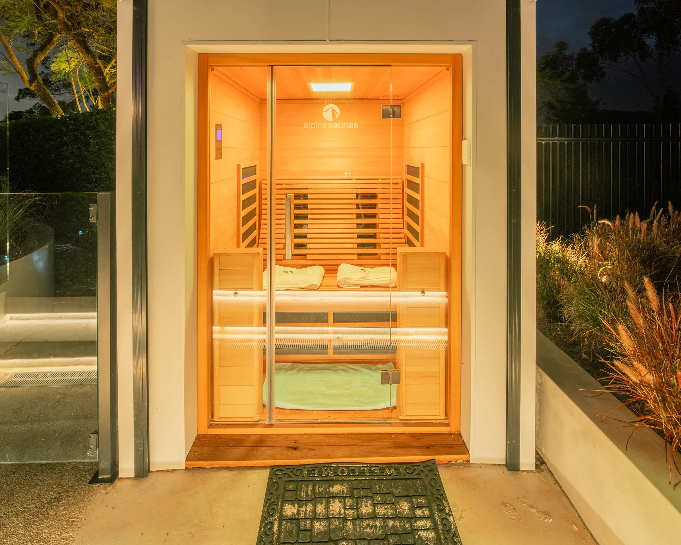 The open sauna with timber benches and warm interior lighting.