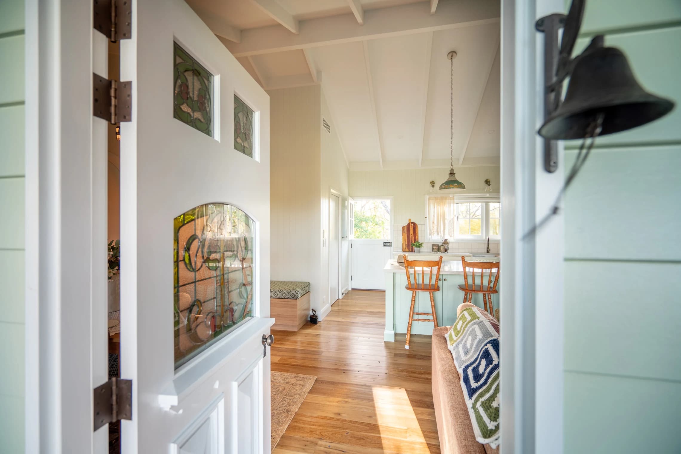 View through the cottage's stained-glass front door towards the kitchen.