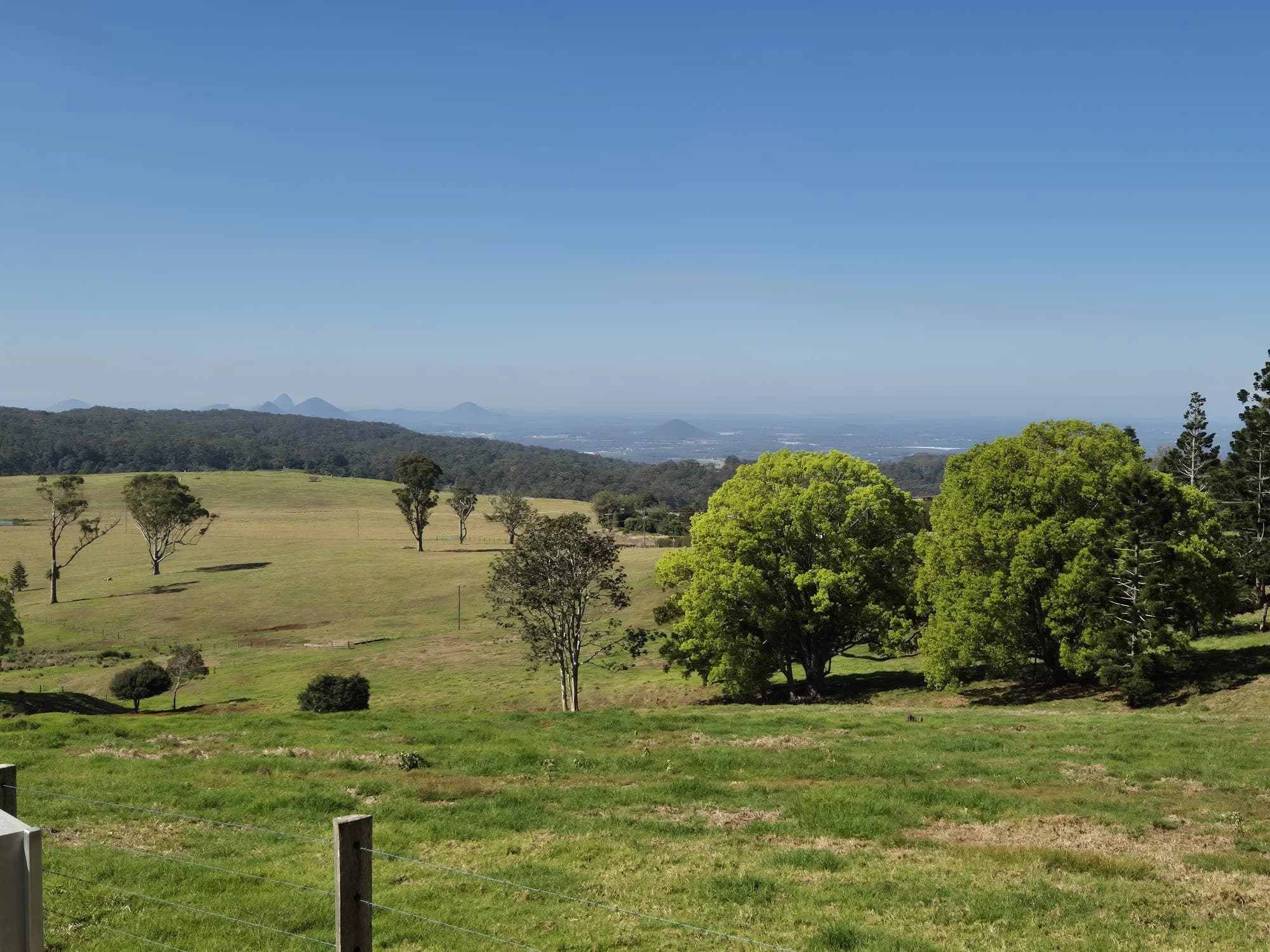 Pastures and distant mountains viewed from the Mt Mee lookout towards the Sunshine Coast.