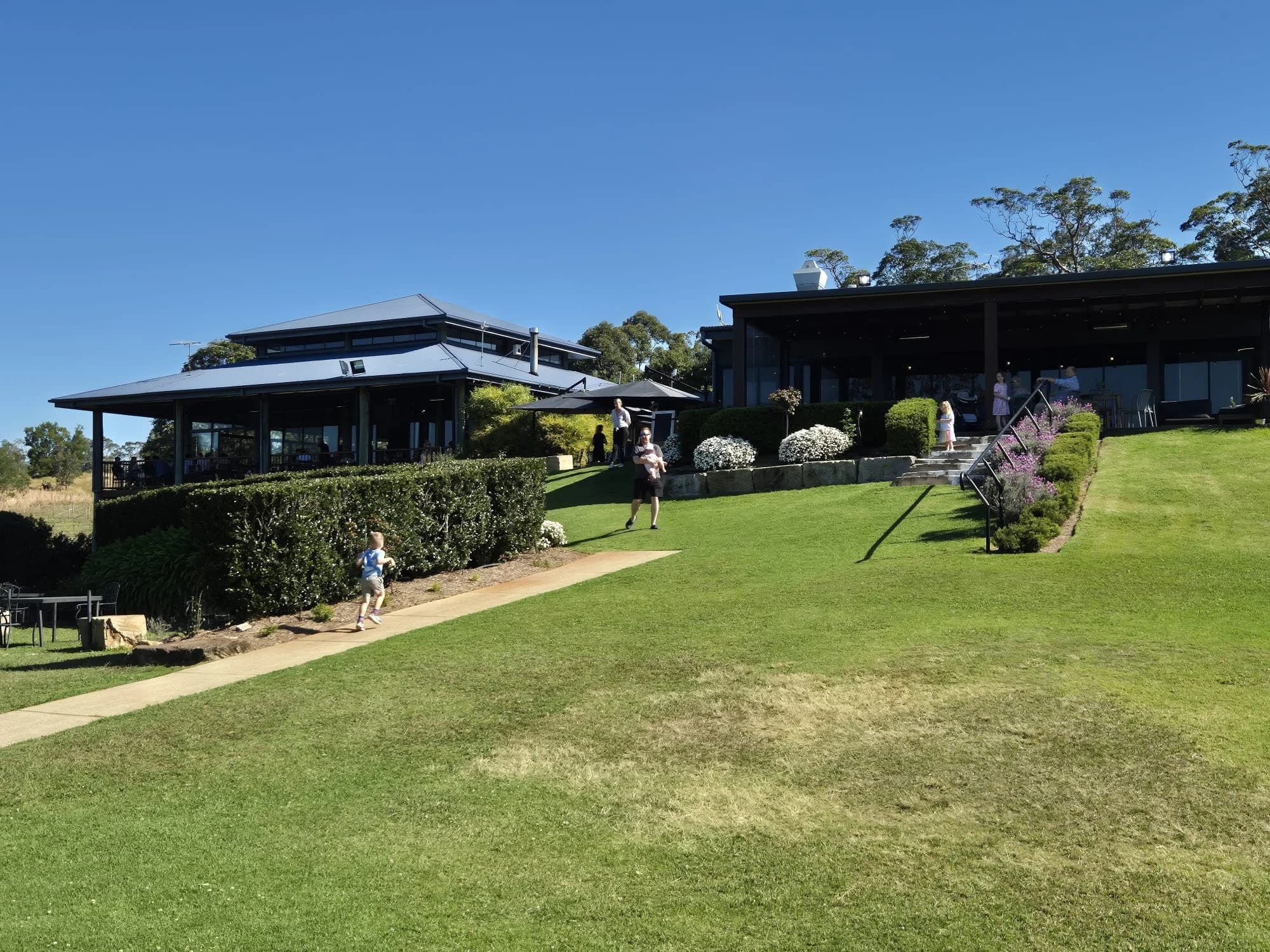 The Ocean View Estates building above a broad green lawn.